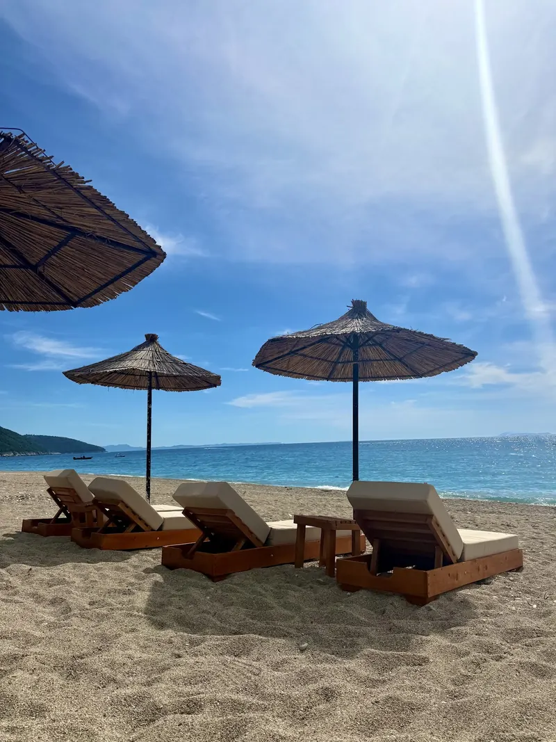 Straw umbrellas and sunbeds on a sandy beach