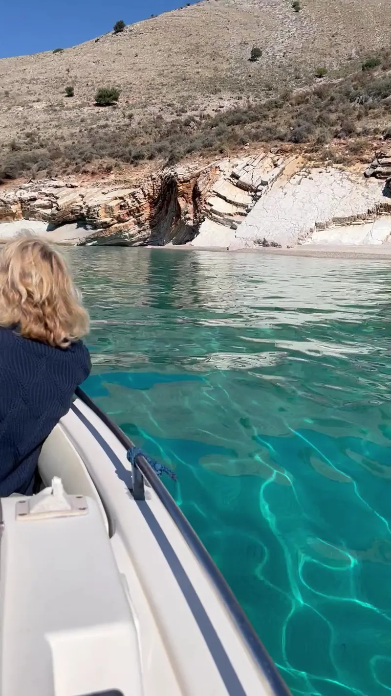 Looking over the bow towards a sea cave in the cliffs